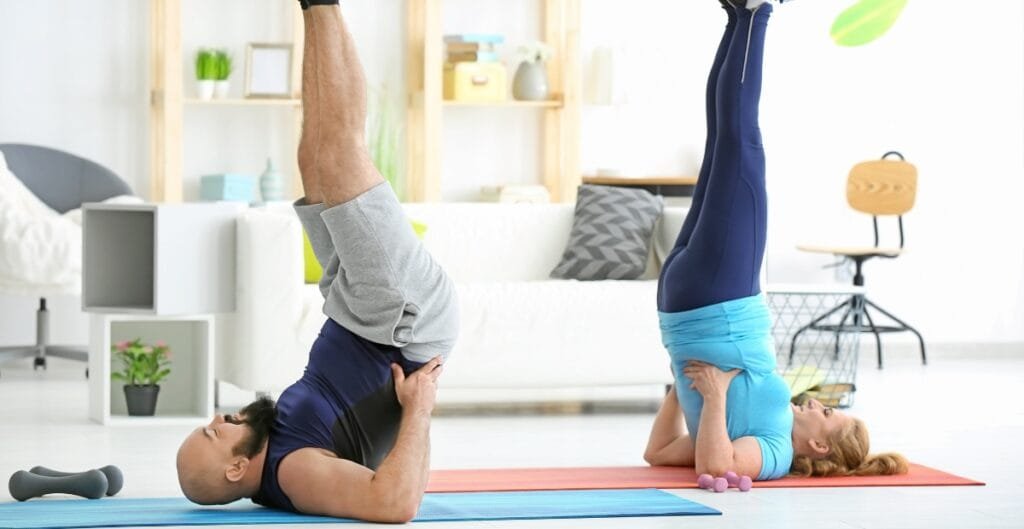 A man and woman performing yoga poses in plus size gym pants, showcasing fitness and wellness for all sizes