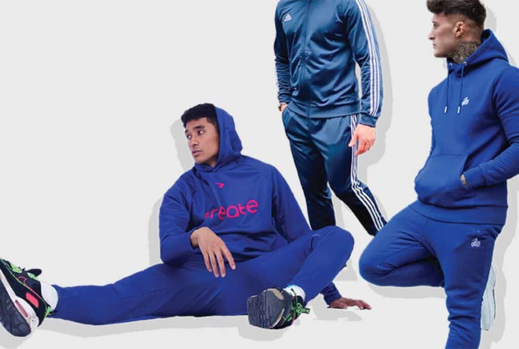 A neat display of affordable sweatsuits on racks in a warehouse showroom.