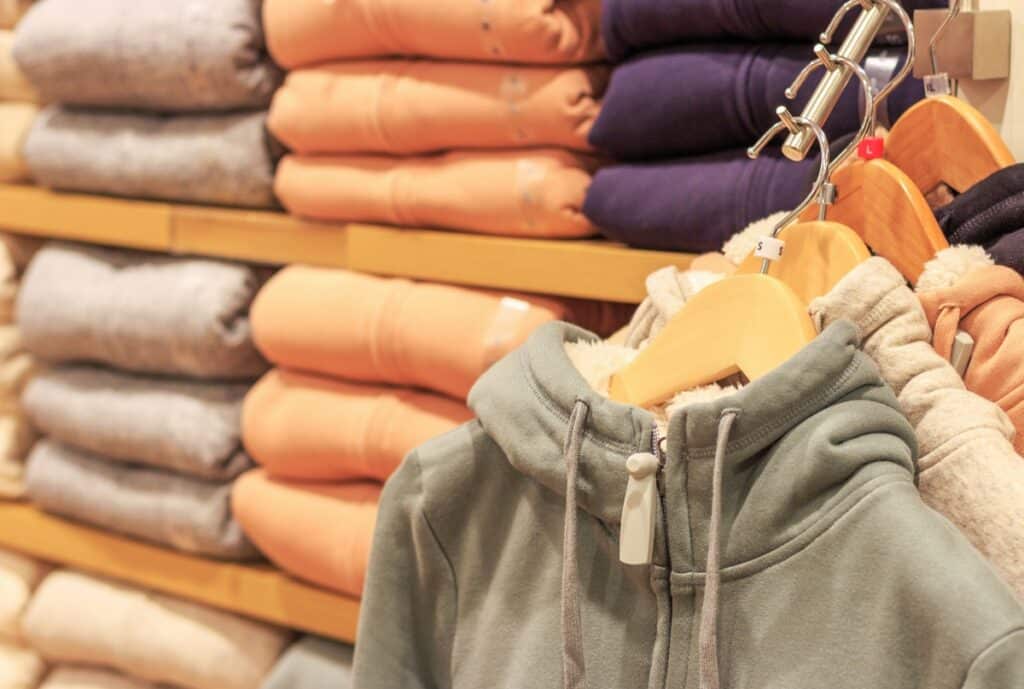 A close-up of a high-quality hoodie showing premium stitching, thick fabric, and a neatly finished drawstring, with a soft-focused background to convey luxury and comfort.