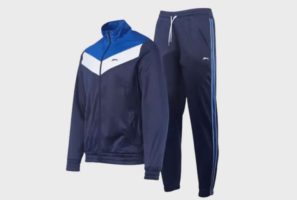 "Blue recycled polyester sweatsuit laid flat to display jacket and pants set."