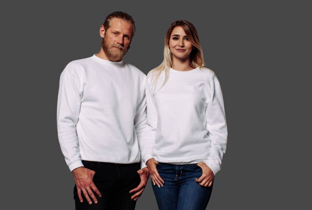 A close-up of a heavyweight sweatshirt in cream color, showing thick fleece interior and double-stitched seams.