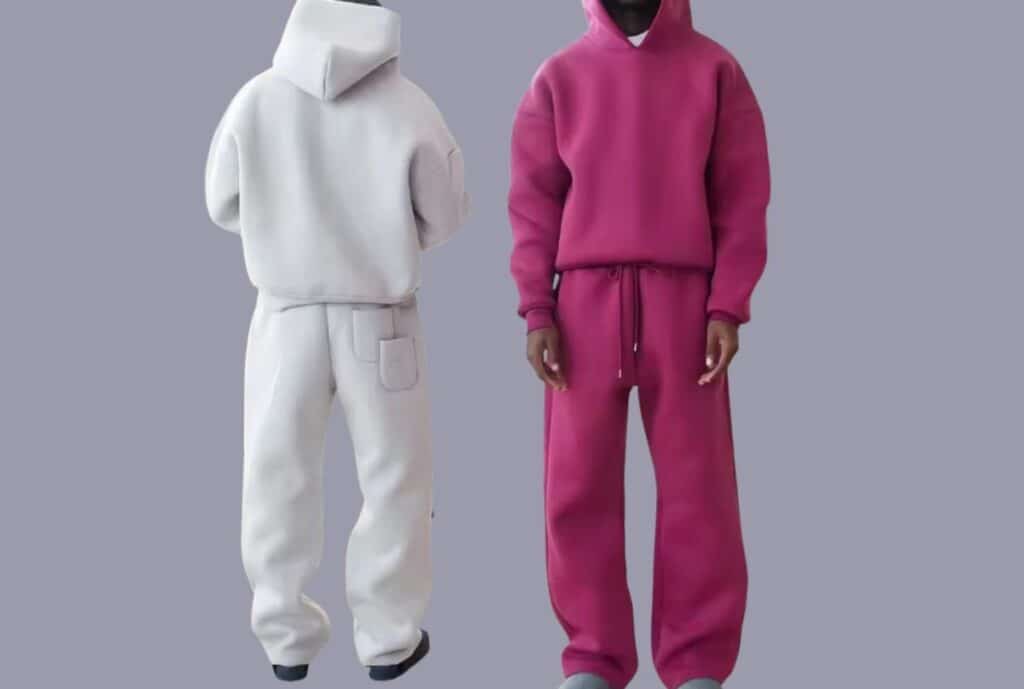 Model wearing a French terry sweatsuit set in navy, standing in an urban outdoor setting.”