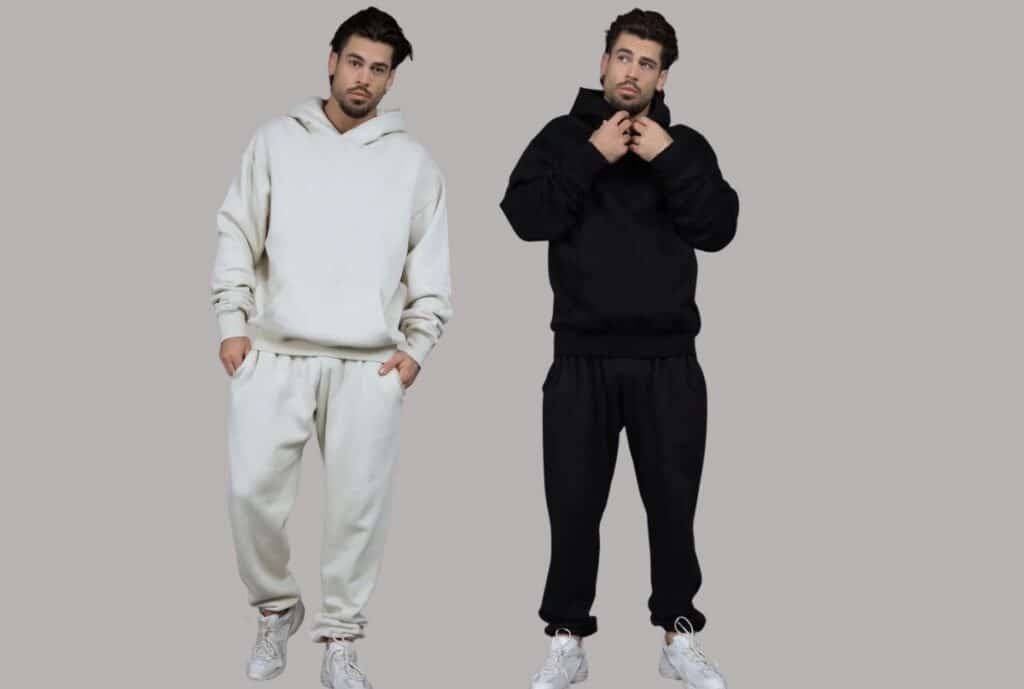 "A model wearing a heavyweight cotton sweatsuit set in a modern showroom, highlighting comfort and fit."