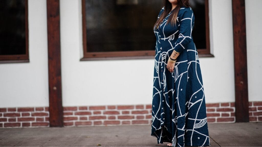 plus maxi dress in navy blue being worn outdoors by a plus-size woman
