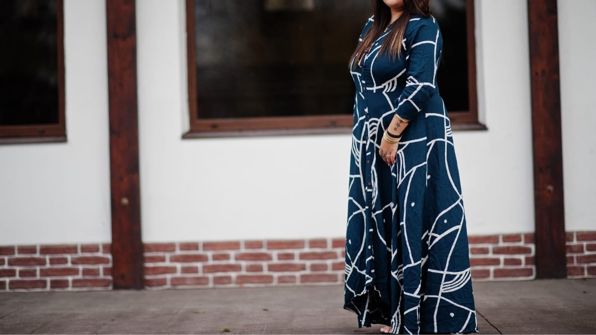 plus maxi dress in navy blue being worn outdoors by a plus-size woman