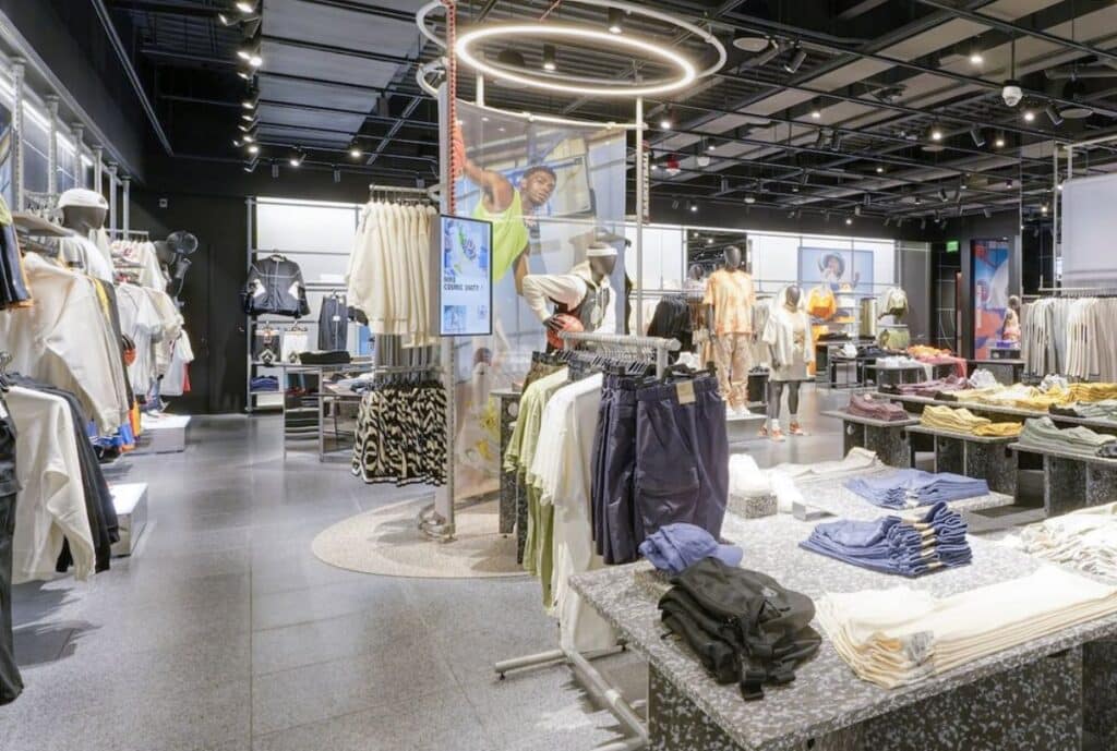 A premium sweatsuit collection displayed on a sleek rack in a modern showroom, with coordinated colorways, plush fabric textures, and a “New York Garment District” tag highlighting quality and urban style.