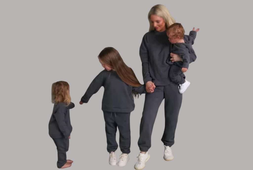 "Brightly colored sweatsuits arranged on display rack at a Charlotte, NC athletic apparel supplier."