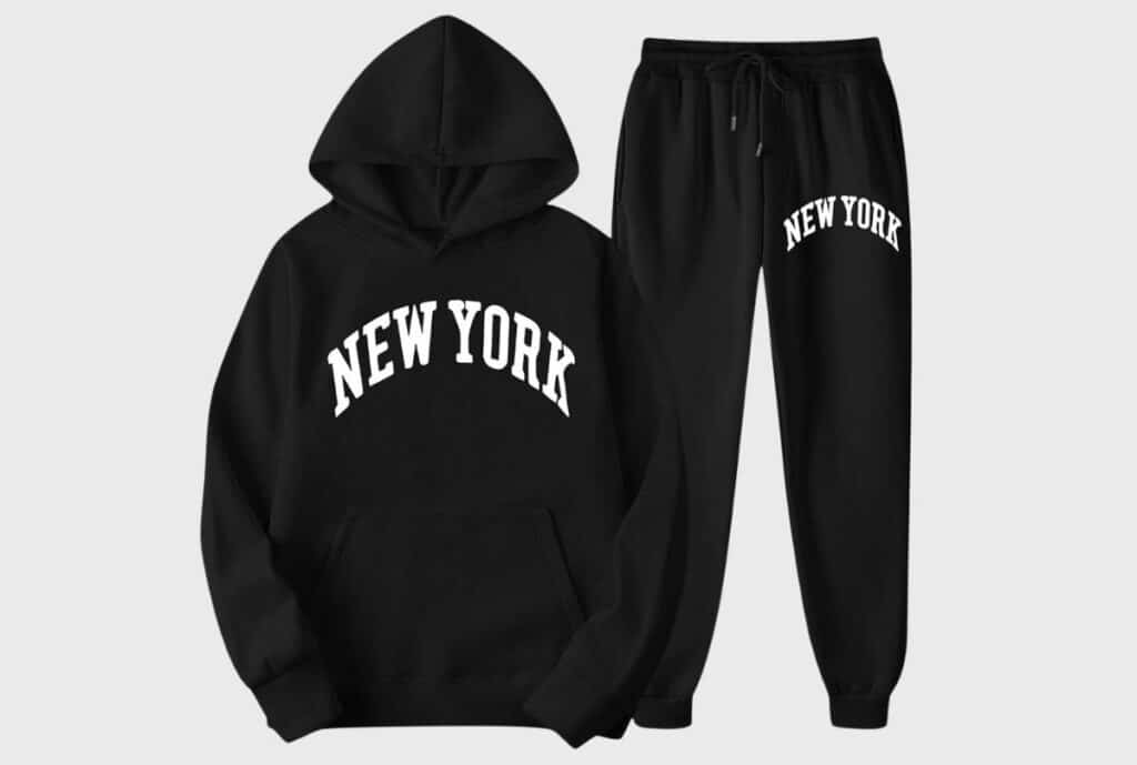 “Premium sweatsuits on display in a showroom, emphasizing luxury fabrics and NYC Garment District branding.”