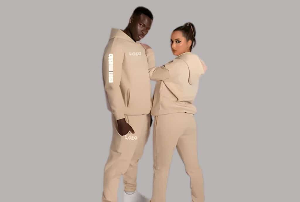 "Detail shot of a charcoal gray fleece sweatsuit with white drawstrings, highlighting fabric texture, from a Charlotte, NC supplier."