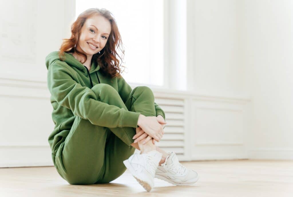 A warehouse shipment of sweatuits including hoodies, sweatpants, and tracksuits stacked and labeled for quick pickup in LA.