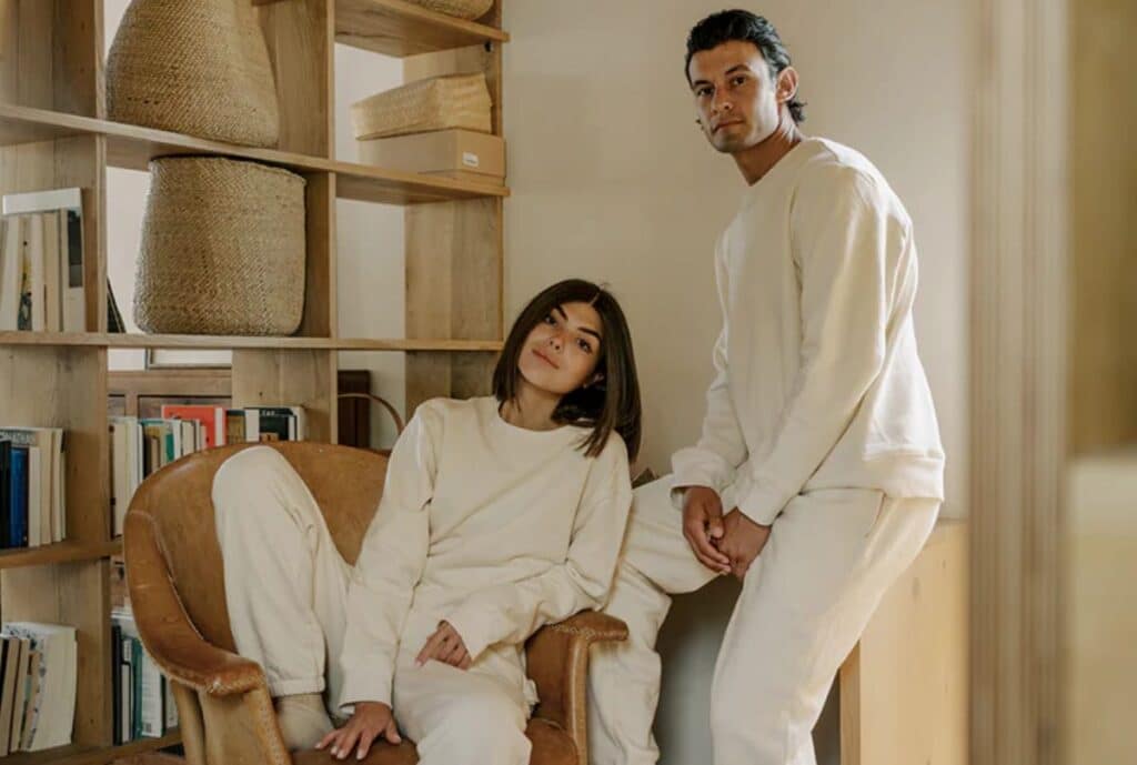 If you need something shorter: "Organic cotton sweatsuit on a mannequin in a minimalist showroom, highlighting sustainable US sourcing."