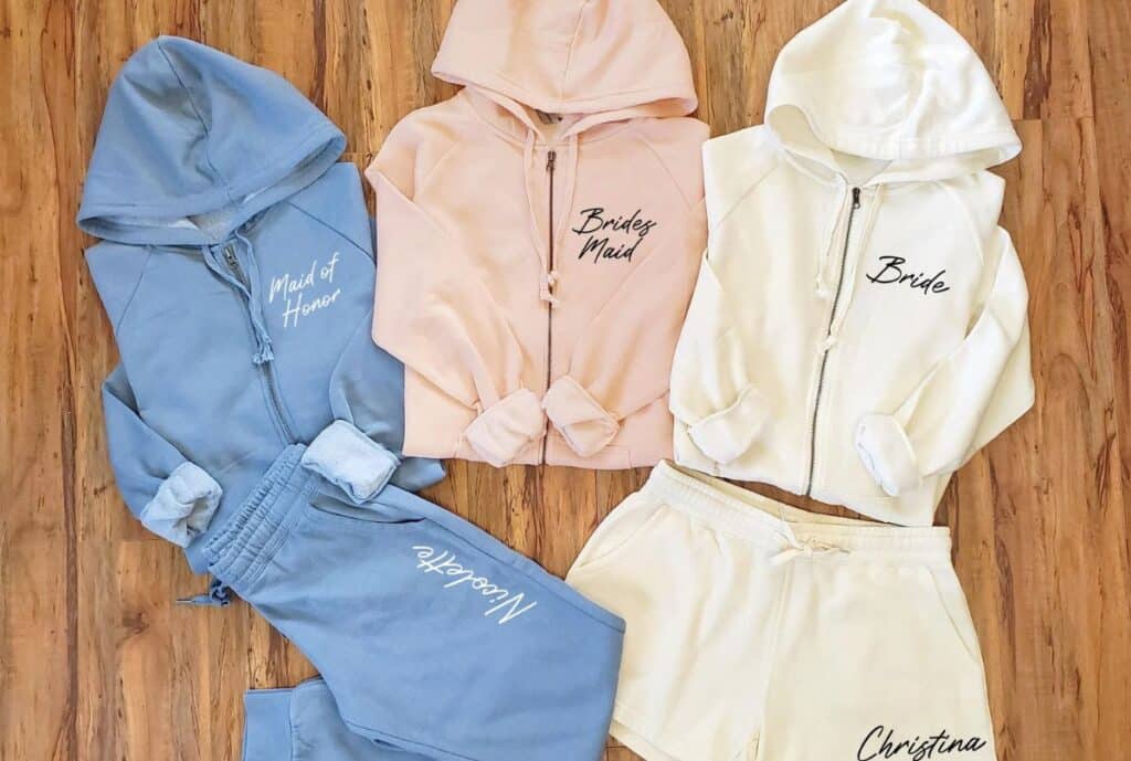 If the image highlights a factory or production: "Modern manufacturing facility with workers sewing private label sweatsuits on sewing machines and inspection stations."