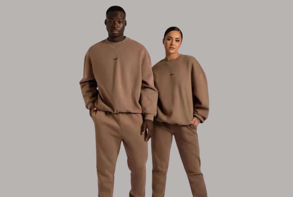 Product close-up: "Close-up of high-quality fabric and flatlock stitching on USA-made wholesale sweatsuit set."