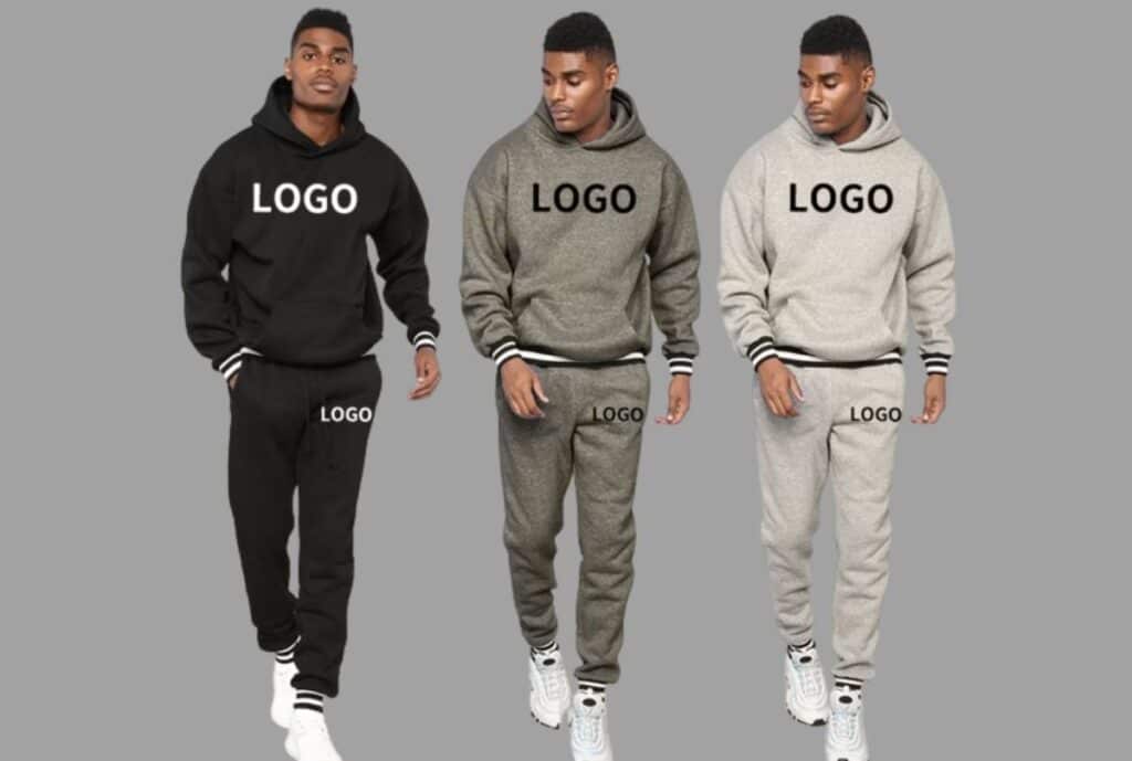 “A warehouse filled with neatly stacked bulk sweatsuits in assorted colors, ready for shipment from a wholesale supplier.”