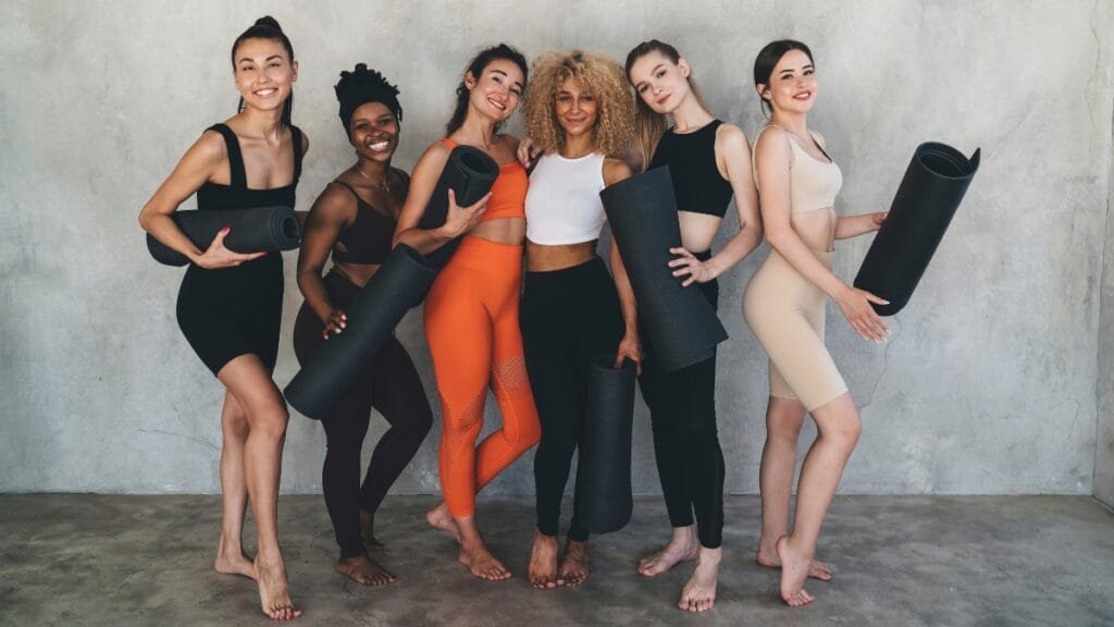 Group of women wearing cute leggings in different colors while posing together