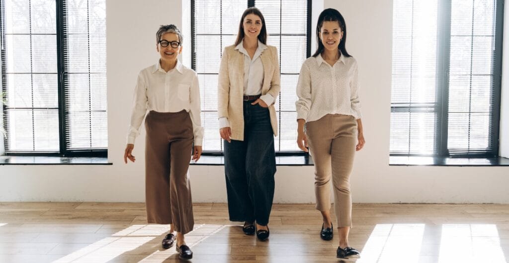 Women in female formal pants showcasing a professional look indoors.