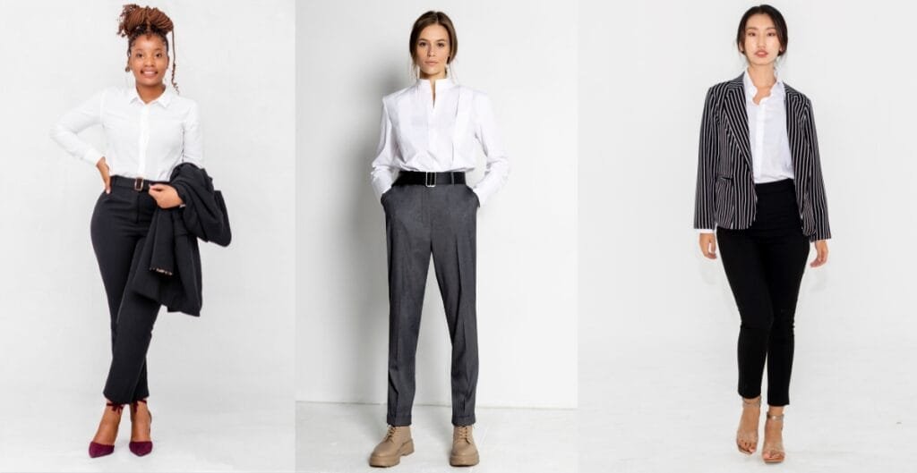 Elegant woman wearing a formal pant dress with a white shirt, a blazer, and heels, standing in a confident pose