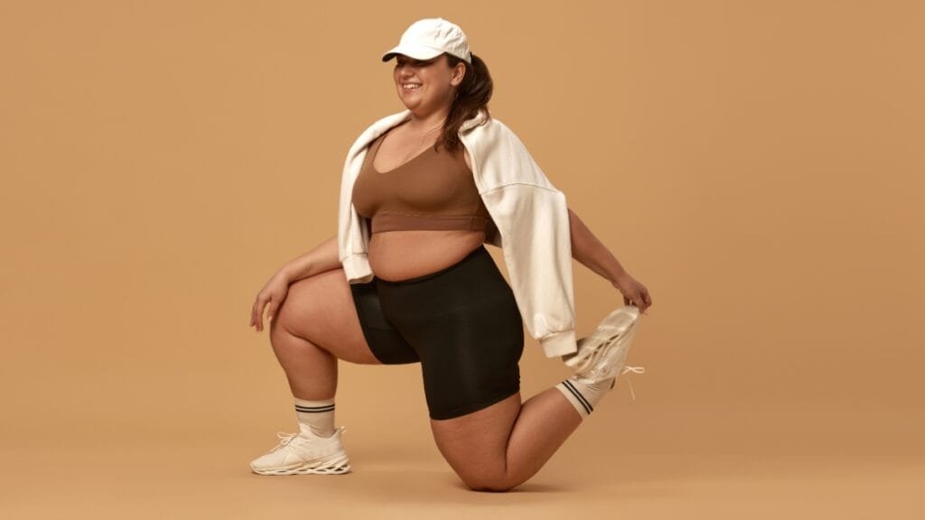 Plus-size woman stretching in athletic shorts, showcasing activewear options