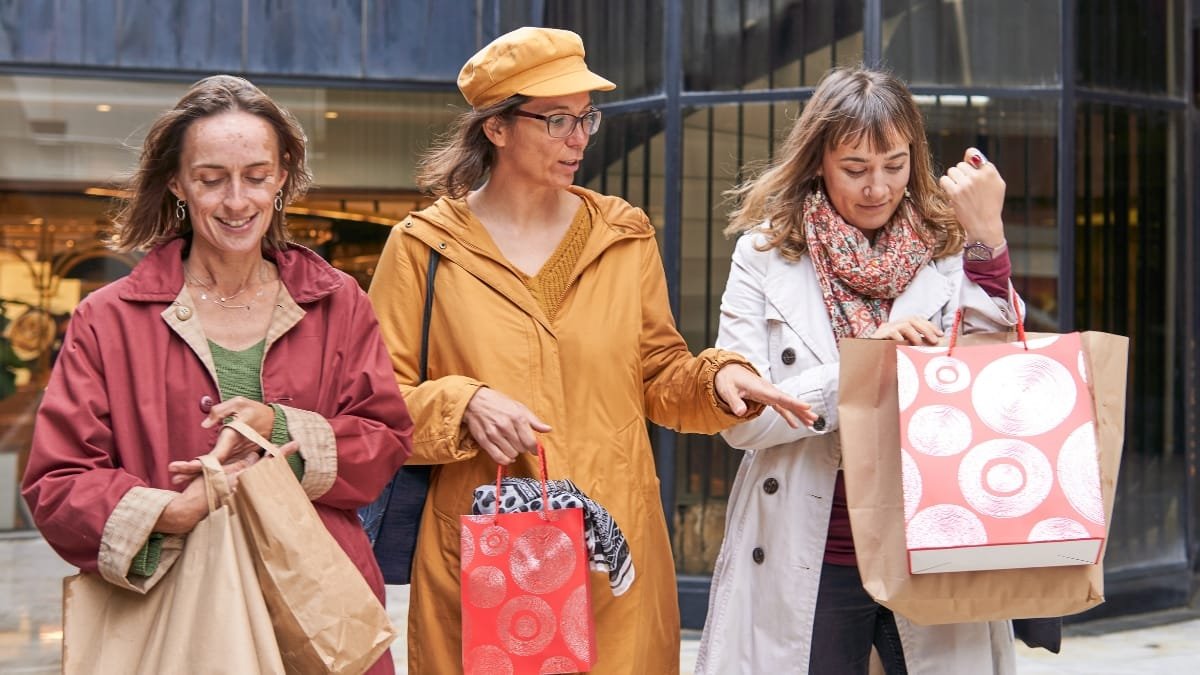 Women Shopping Together Outdoors After a Day of Buying Gifts
