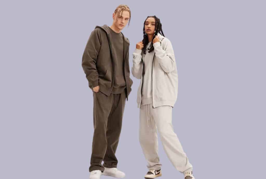 Mannequin display of stylish athleisure sweatsuits in a bright showroom.