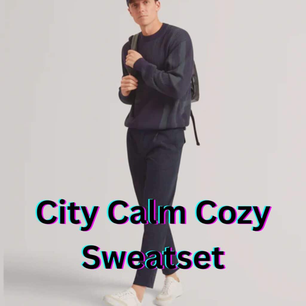 A man wearing a dark blue textured sweater and matching navy sweatpants, paired with white sneakers and a backpack, giving a calm and stylish vibe for a city-ready, cozy look.