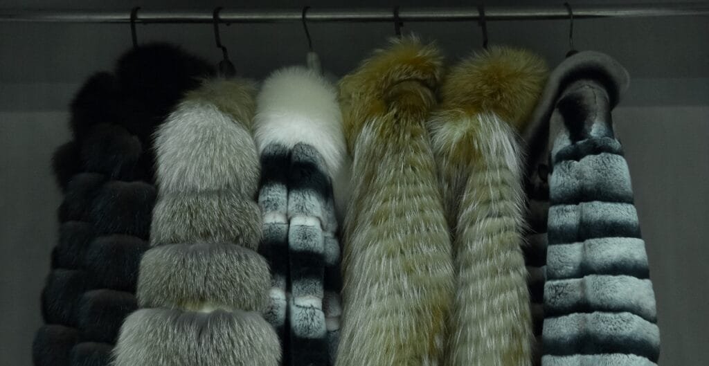 "Close-up of a winter coat showing textured recycled wool fabric, highlighting sustainable materials used in 2025 outerwear."