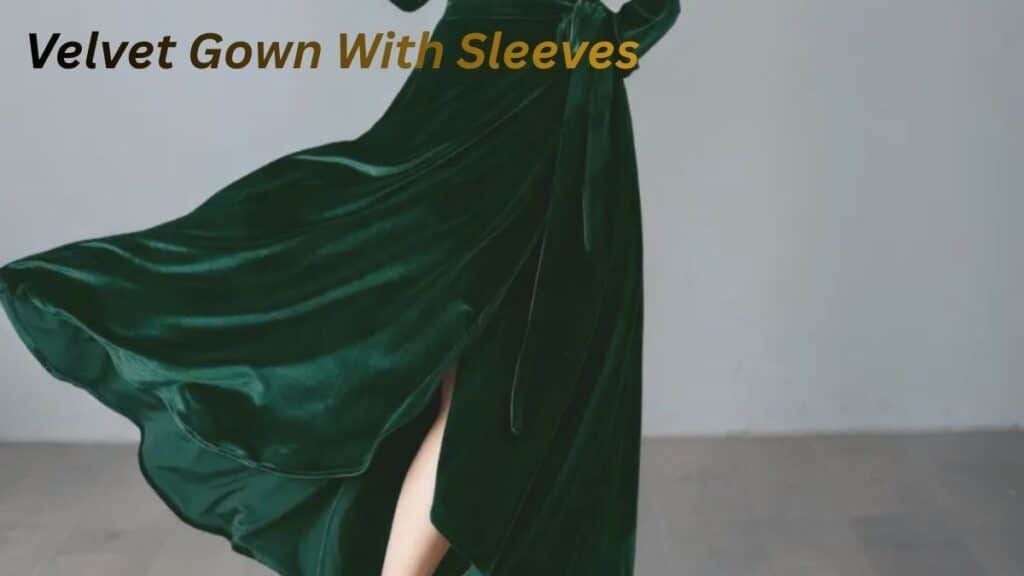 "Elegant woman wearing a green velvet gown with sleeves, showcasing a flowing design and a stylish slit, tied at the waist."