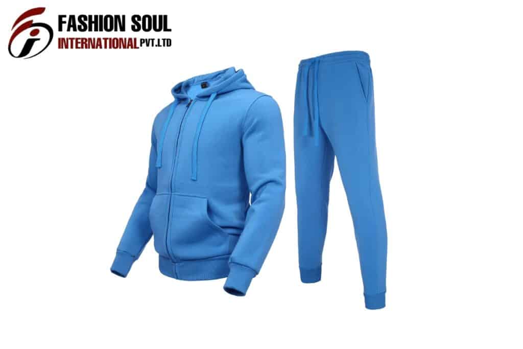 A blue hoodie and matching jogger pants set displayed next to each other with a fashion brand logo in the top left corner.