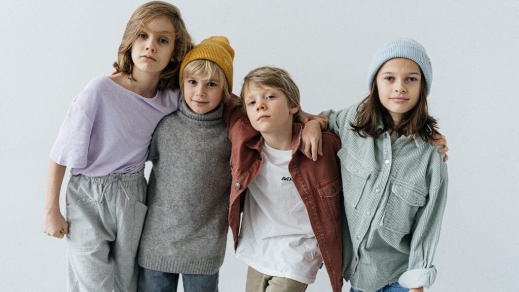 Children dressed in casual clothes, including t-shirts, sweaters, and hats, perfect for 9-year-olds