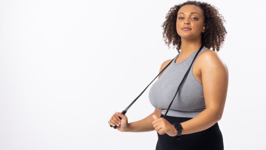 Plus-size woman wearing a full figure sports bra while exercising with resistance bands