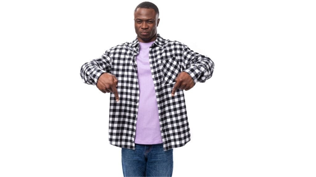 Man showing a black and gray flannel shirt big and tall worn over a pink tee