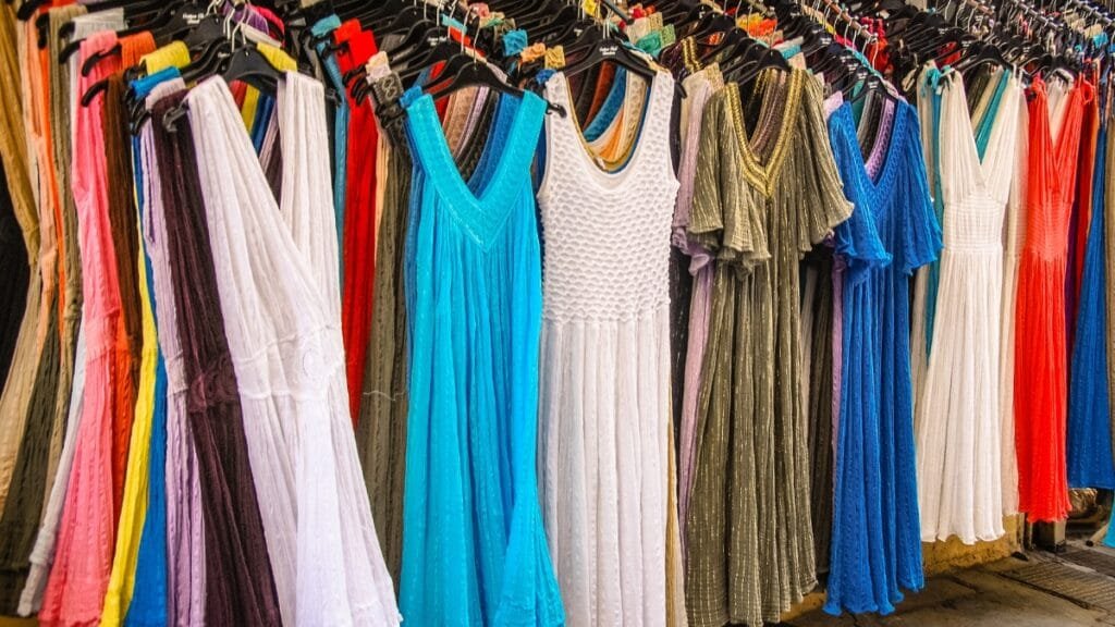Colorful inexpensive midi dresses hanging on display in a store