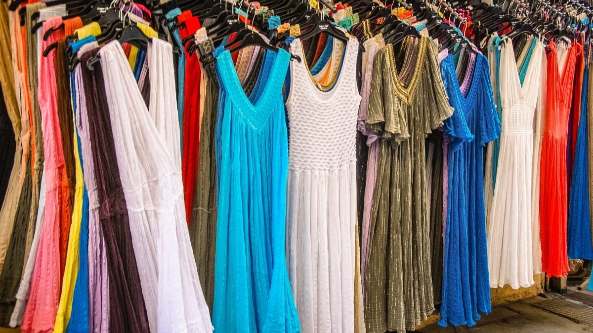 Colorful inexpensive midi dresses hanging on display in a store