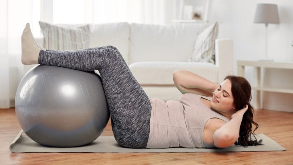 Plus size woman exercising at home, wearing activewear sweatpants for a workout
