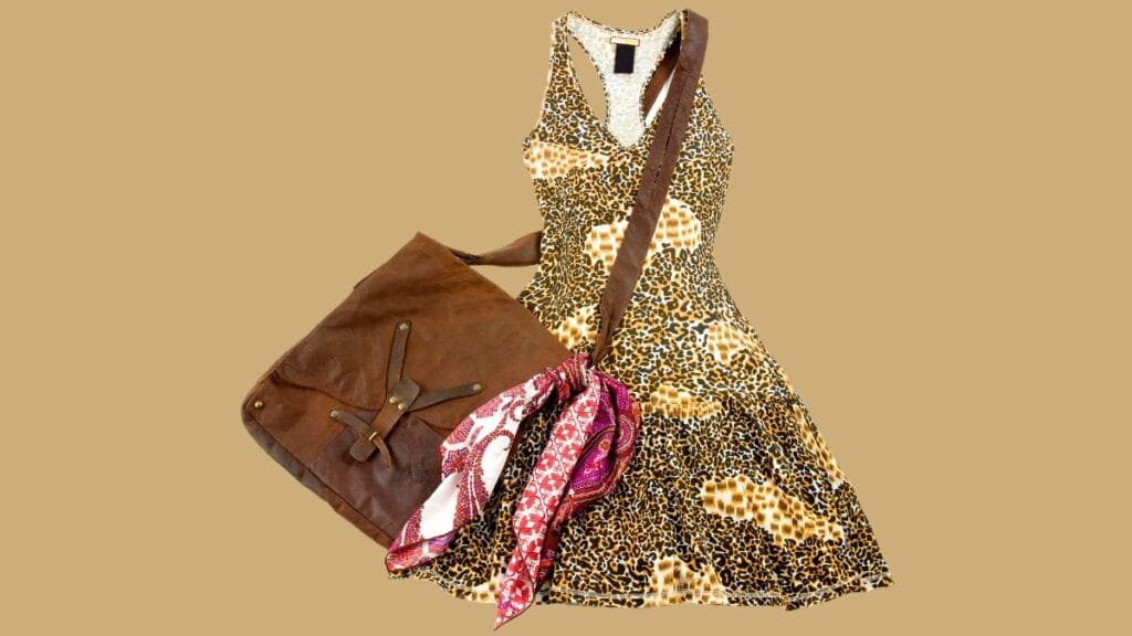 Size 12 women's dress with a leopard print pattern, paired with a brown leather handbag and a colorful scarf.