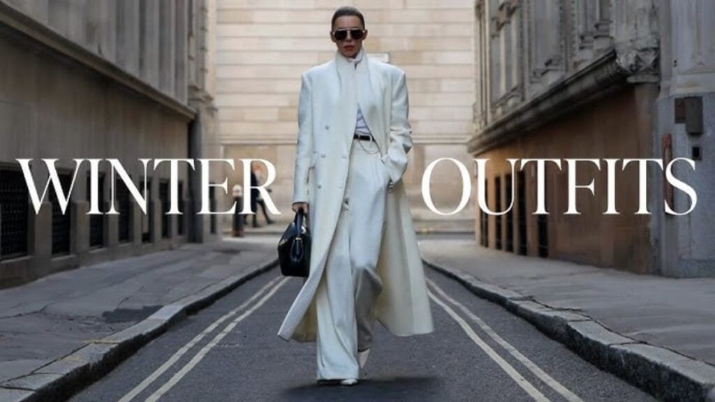 "Fashionable winter outfit with a white coat and pants on a city street."