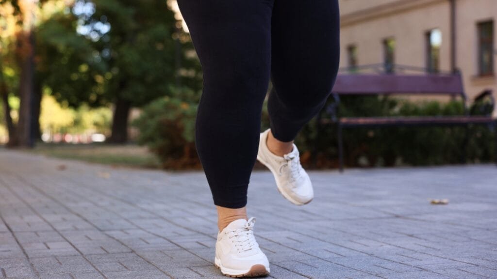 Close-up of womens plus size joggers paired with white sneakers for a comfortable walk