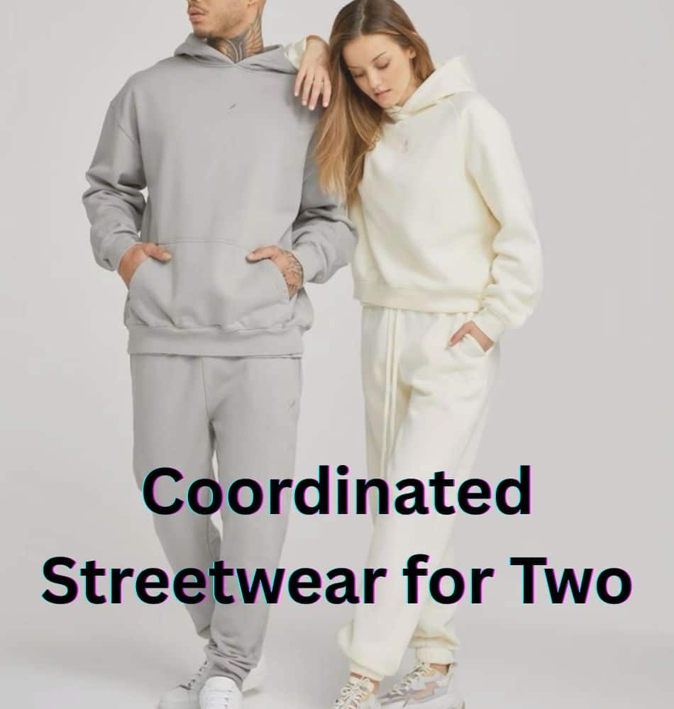 A couple models pose in matching oversized hoodies and jogger sets; the man wears a light gray ensemble and the woman wears an off-white set. They stand close, hands in pockets, against a plain backdrop. Bold text overlays read “Coordinated Streetwear for Two.