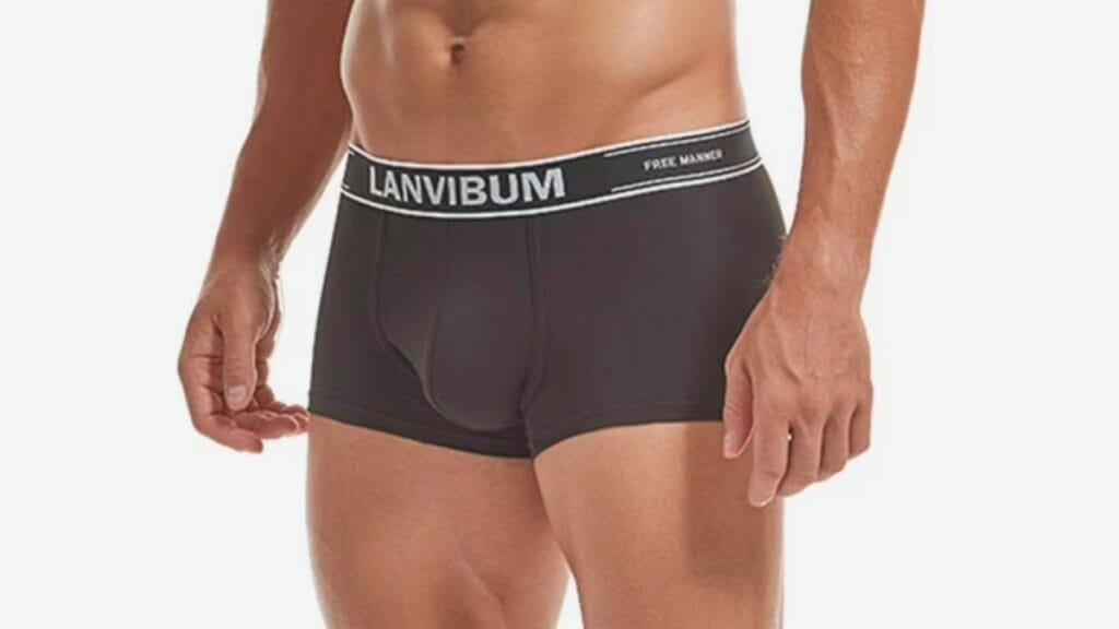 Close-up of a man wearing black boxer briefs with a white waistband that reads ‘LANVIBUM’ and 'FREE MARGIN' along the band.