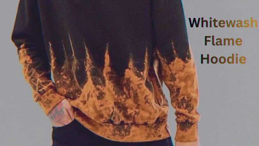 Black hoodie with a bleach-style gradient fading to burnt orange at the bottom, featuring a jagged, flame-like edge and orange-brown leaf patterns along the hem and sleeves