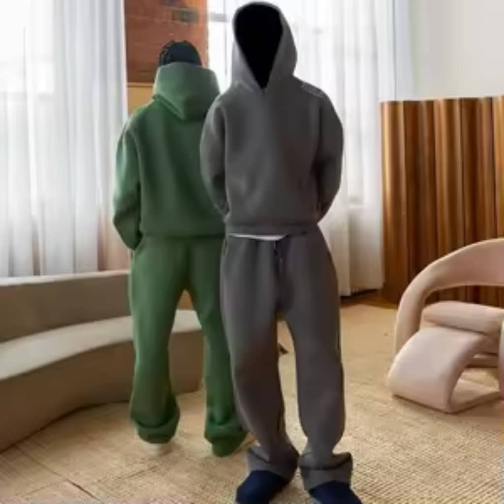 A wholesale sweatsuit manufacturer in Miami showroom with racks of athletic suits and a business team reviewing catalogs.