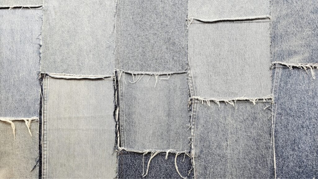 Denim vs Cotton: Close-up of denim fabric patchwork showing different shades and textures