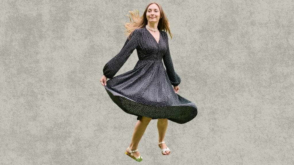 Woman twirling in a dress outdoors, showcasing the flow and movement, perfect for wearing dress spanks
