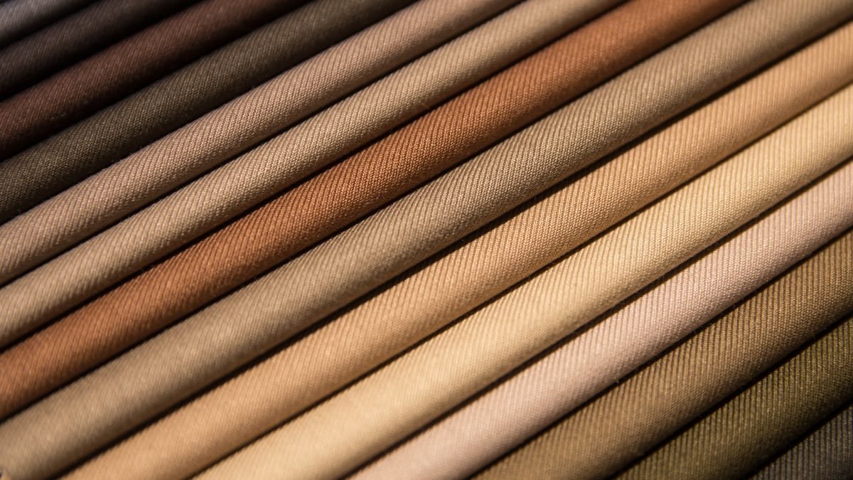 A collection of different shades of brown fade-resistant fabric arranged neatly in rows