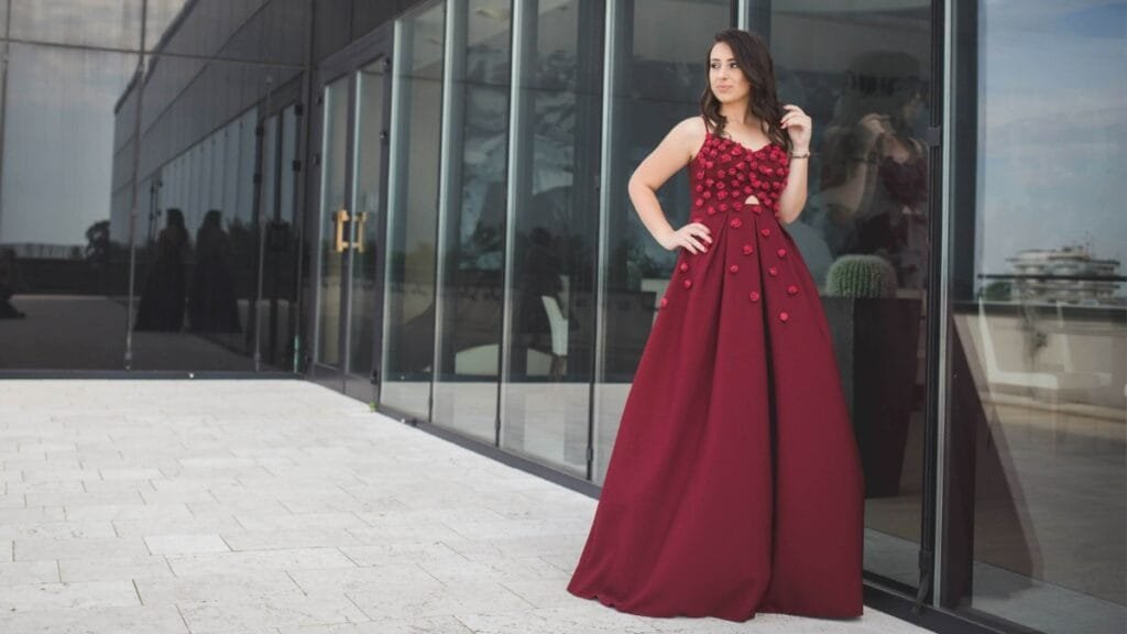 Size 16 prom gown featuring burgundy fabric with floral embellishments