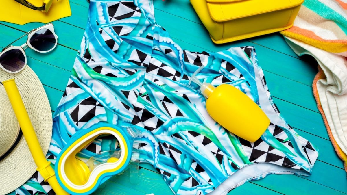 Swim trunk fabric with tropical design and beach accessories