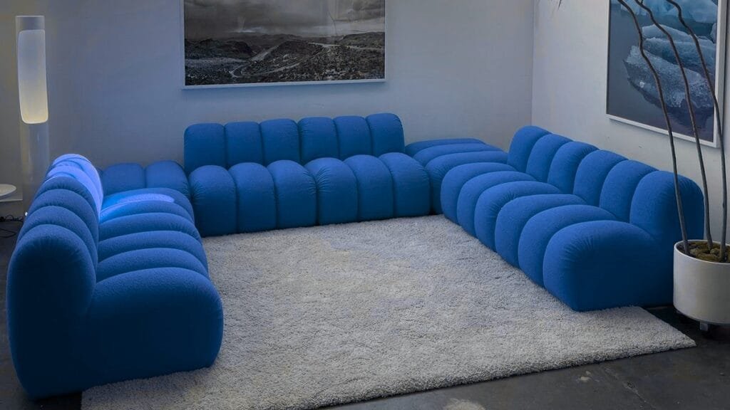“A stylish living room featuring a light gray fabric sofa with wooden legs and a cozy throw.”