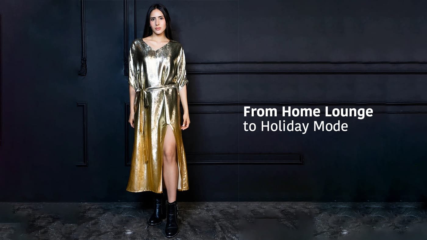 Woman wearing a gold metallic dress and black boots in a studio with text reading “From Home Lounge to Holiday Mode”.