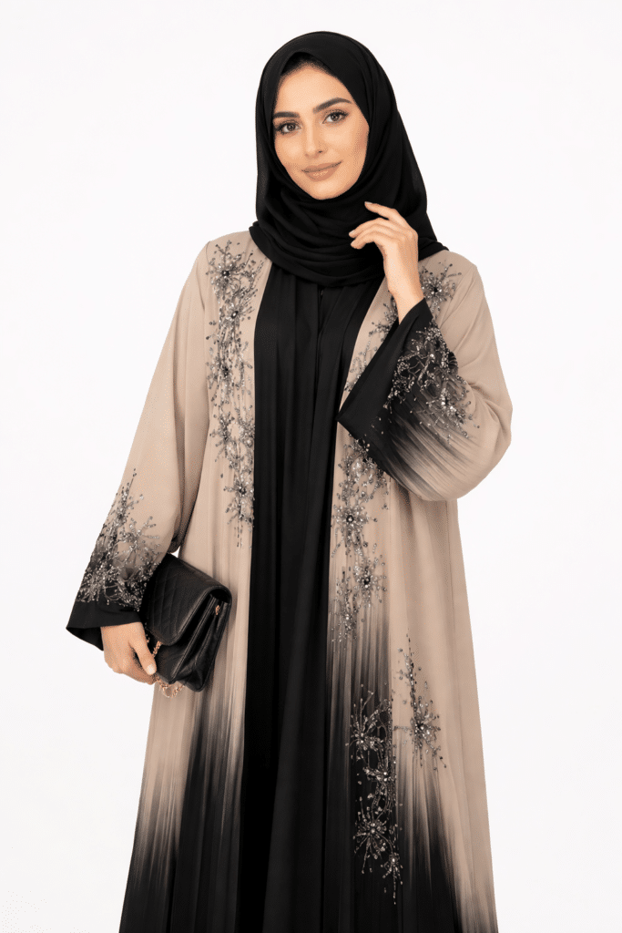 Elegant two-tone Dubai abaya with silver embroidery on the front and sleeves, styled with a matching black hijab and small black handbag.