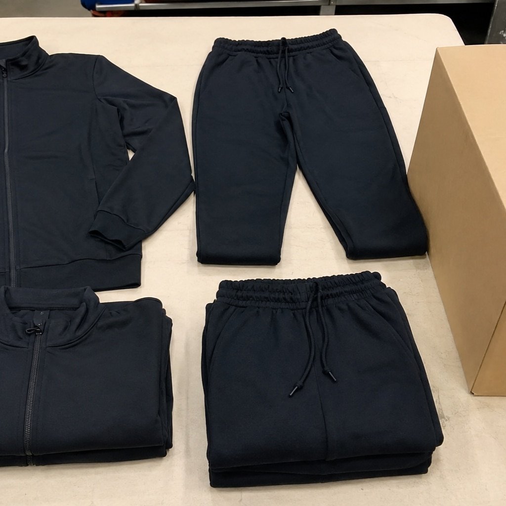 Custom tracksuit manufacturing and export packaging with brushed fleece sportswear ready for international shipment and quality inspection.